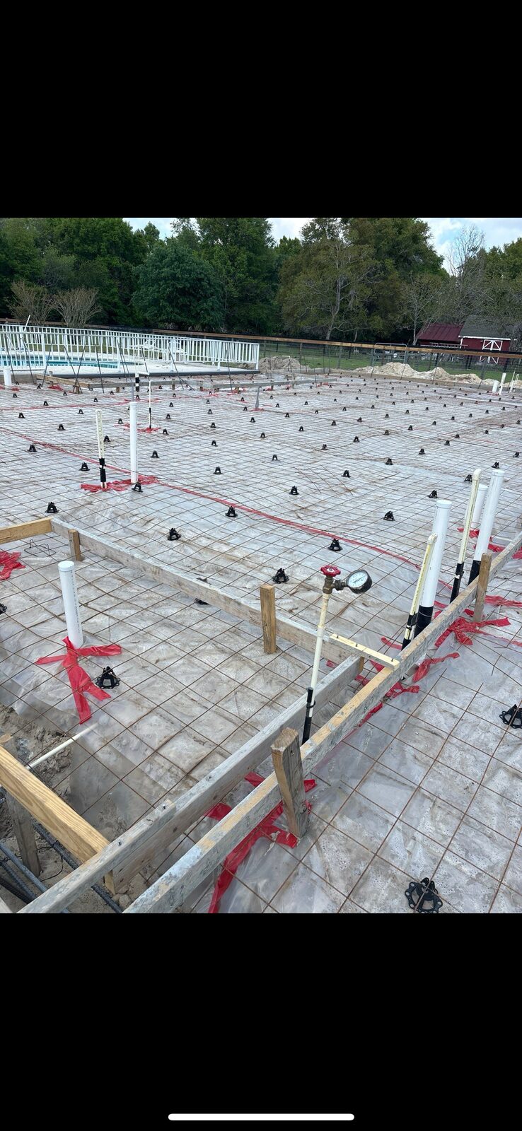 Residential foundation slab with rebar grid and plumbing stub-outs