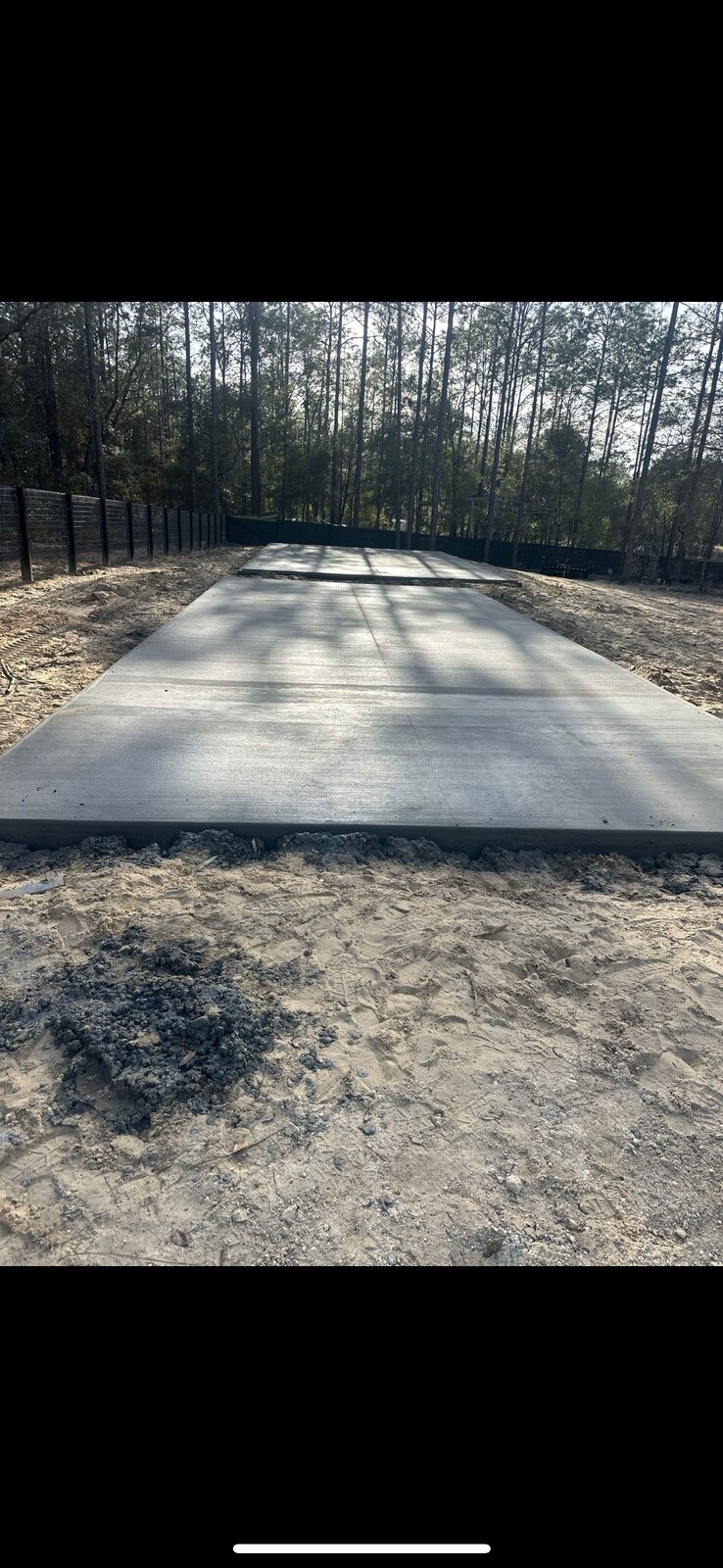Concrete pad finished on wooded residential lot
