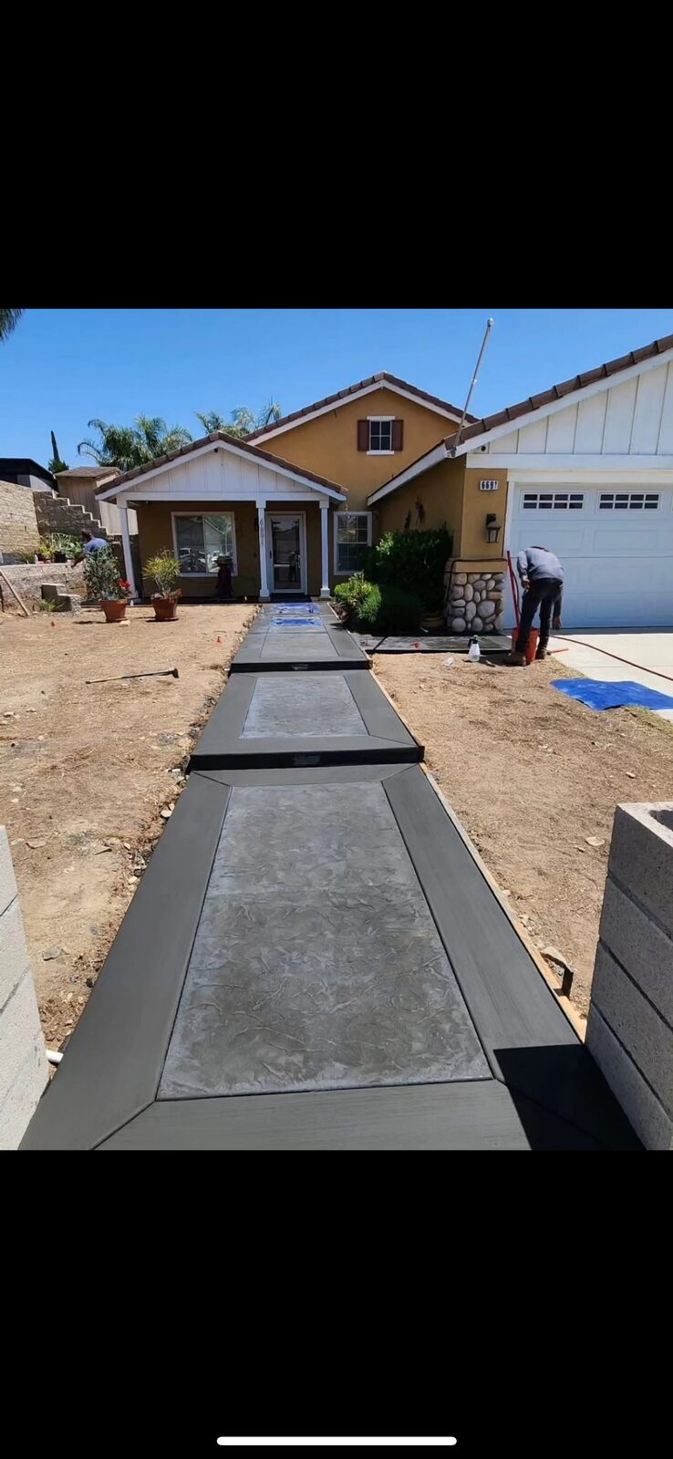 Decorative stamped concrete walkway leading to residential home
